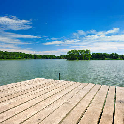 Lake amongst the woods, cloudy summer sky