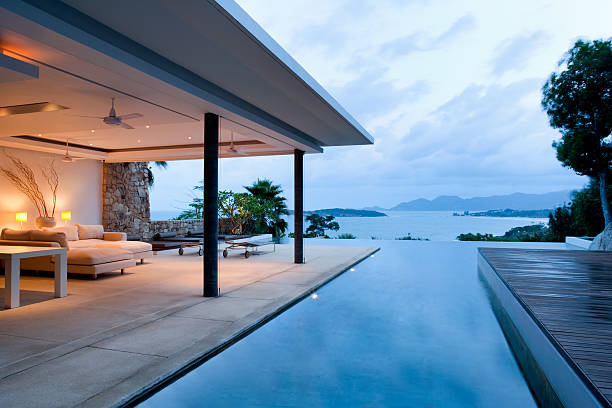 Modern Island Villa Luxury Island Villa With Infinity Pool At Sunset. infinity pool stock pictures, royalty-free photos & images