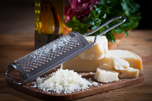 Parmesan cheese with grater.