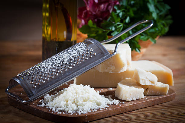 Parmesan cheese with grater stock photo