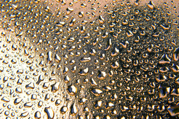 istock Drops of water on a colored background. Abstract texture 1551642223