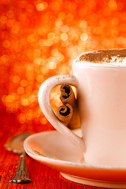 festive cup of hot  drink with cinnamon sticks