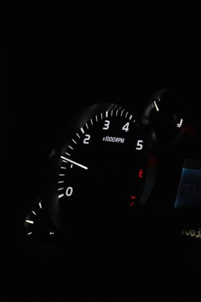 the speedometer is shining in the dark at night time Illuminated speedometer at night, providing a bright indication of speed Revving stock pictures, royalty-free photos & images