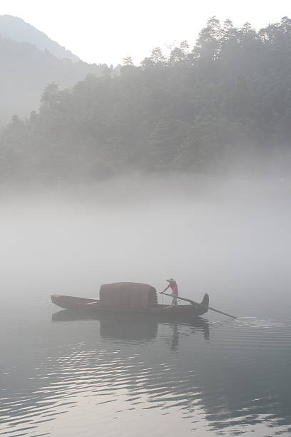 istock fishermen in the fog preparing to fish 155169720