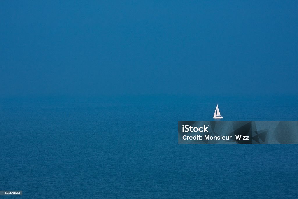 Just alone sailboat on the blue ocean Sailboat Stock Photo