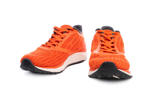 Pair of orange sport sneakers isolated on white background