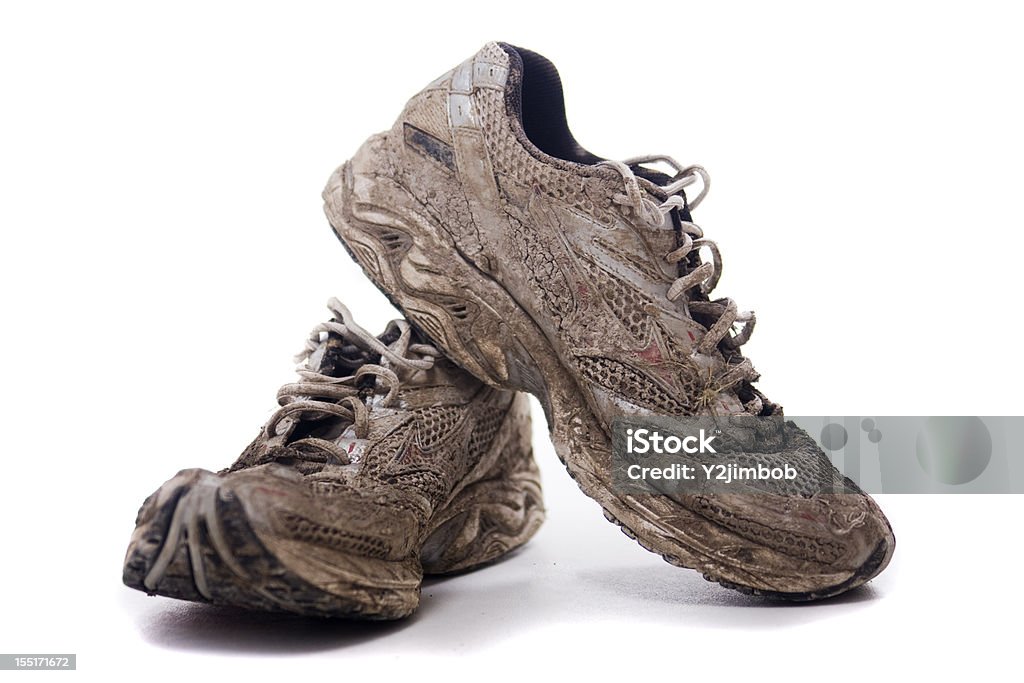 Muddy Sport shoes A pair of muddy sports shoes or trainers. Mud Run Stock Photo