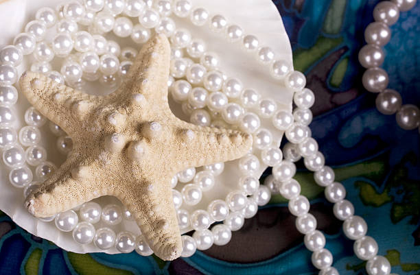 Starfish and pearls stock photo