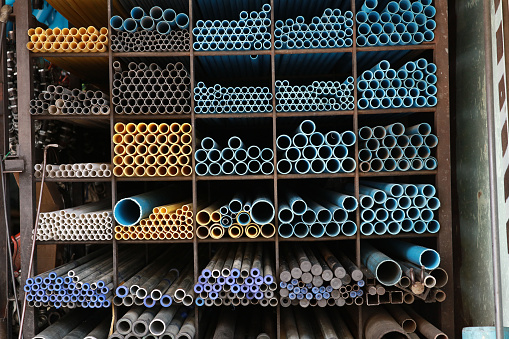 Industrial material, a Variety of types of pipe on the shelf of the warehouse for sale.