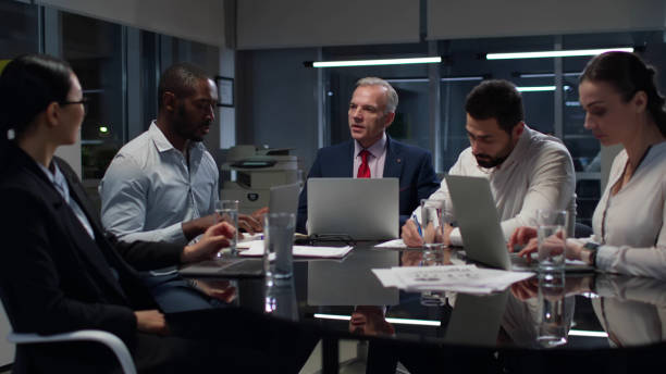 istock Multiethnic business colleagues discuss financial strategy having meeting in office 1551764021