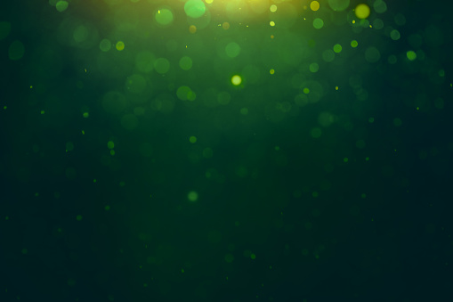 dark green background with gold out-of-focus backlight. festive background for St. Patrick's Day