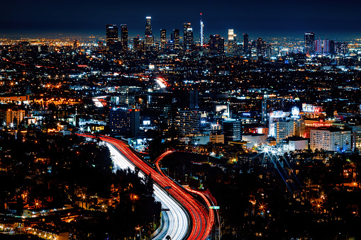 The Los Angeles skyline shines at night from up on top of Mulholland Drive.