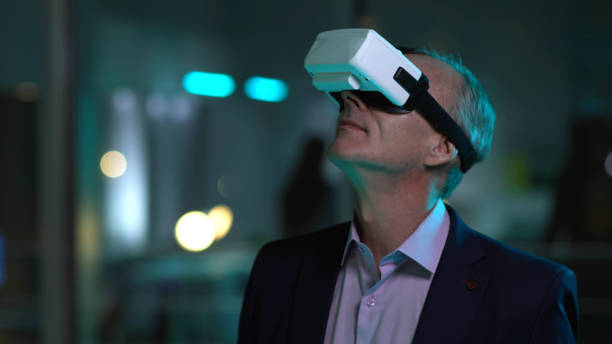istock Mature businessman in vr goggles working late in office 1551829922