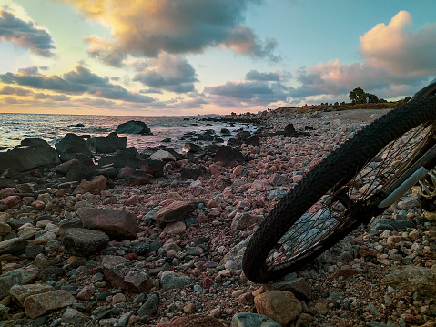 Mountain bike parked at empty rocky beach, punta carretas, montevideo, uruguay