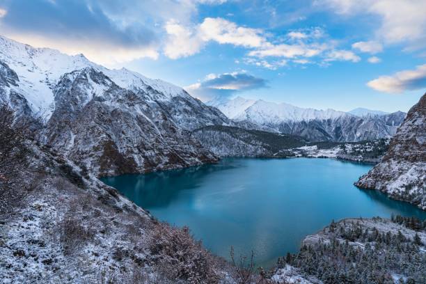 istock Tranquil landscape of an alpine lake, surrounded by majestic snow-covered mountains 1551908277