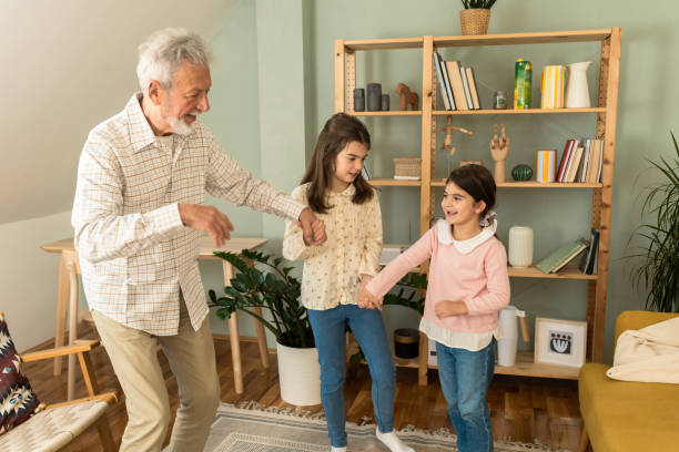 istock Playful grandfather spending time with his granddaughters 1551923472