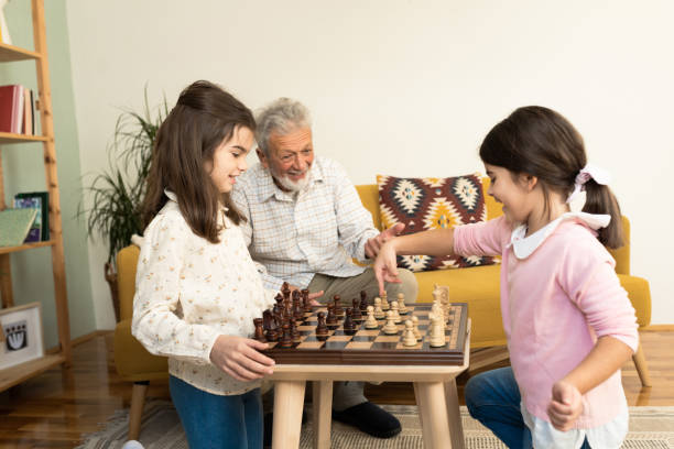 istock Playful grandfather spending time with his granddaughters 1551923986