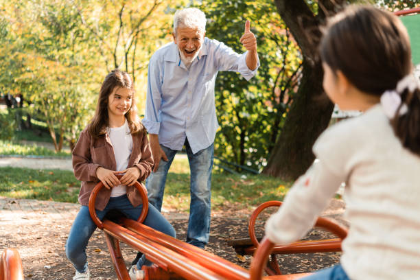 istock Playful grandfather spending time with his granddaughters 1551923996