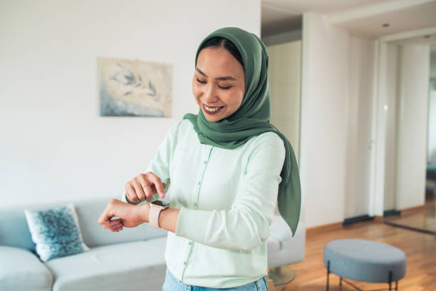 istock Woman using smartwatch at home 1551943856