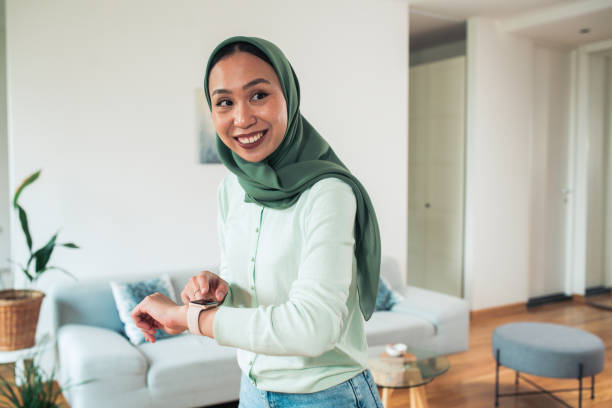 istock Woman using smartwatch at home 1551943859