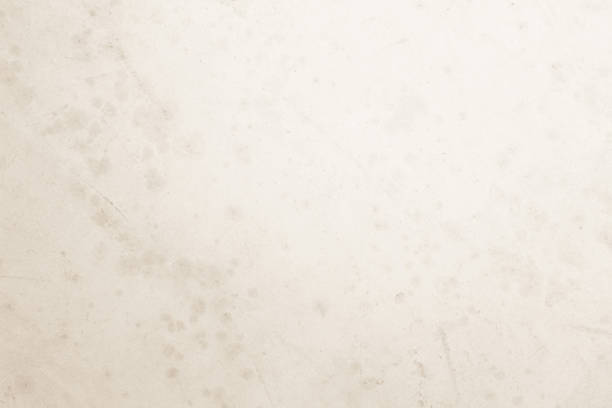 istock Colour old concrete wall texture background. Close Up retro plain cream color cement wall background texture. Design paper vintage parchment element show or advertise or promote product on display. 1551951426