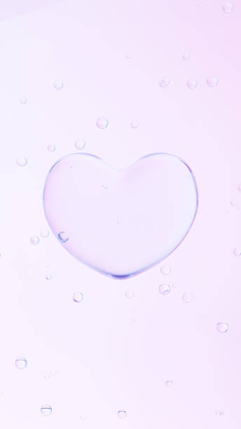 istock 3D Illustration.Transparent heart and multiple bubbles on pink background. (Vertical) 1552035555