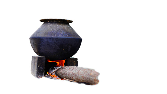 Traditional stoves used by residents in rural India, made of clay, fueled with wood on white background.