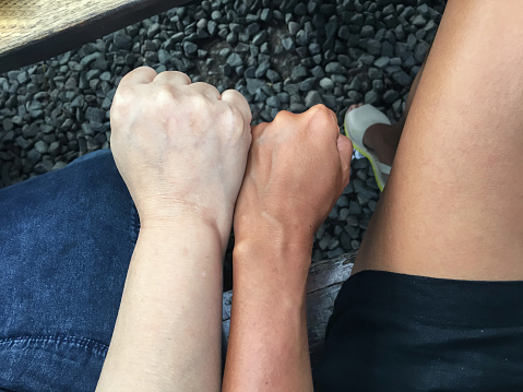 Close-up shot of two different skin color from two unrecognizable people. ( diversity, anti-racism concept )