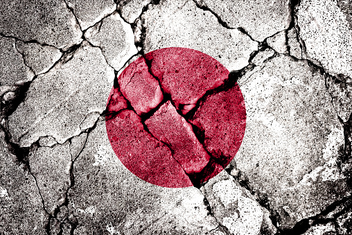 Double exposure of the flag of Japan with cracks in the gravel. A symbol of disintegration or division is depicted. Steps toward collapse. Useful for basemaps or report descriptions