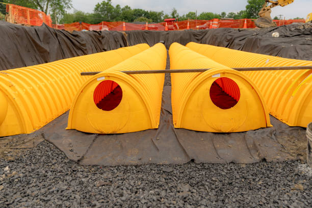 Yellow underground storm water detention mitigation units on a construction site ready to be covered.  Abstract rounded shape.