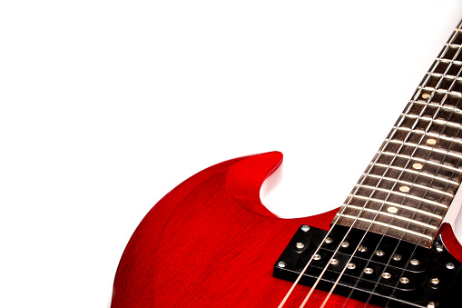 Cherry red electric guitar isolated on a white background with plenty of copy space