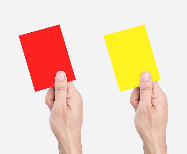 istock Hand hold red and yellow card isolated on white background with clipping path 1552151263