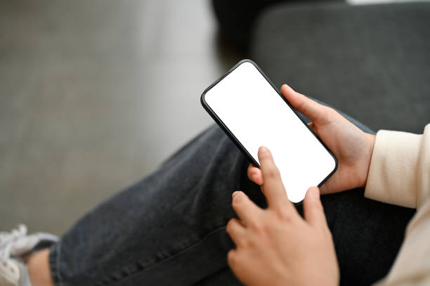 istock A woman using her smartphone while relaxing in a cafe. smartphone white screen mockup 1552172144