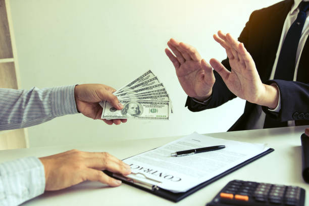 istock Businessperson refusing bribe given money by partner with anti bribery corruption concept. 1552184161