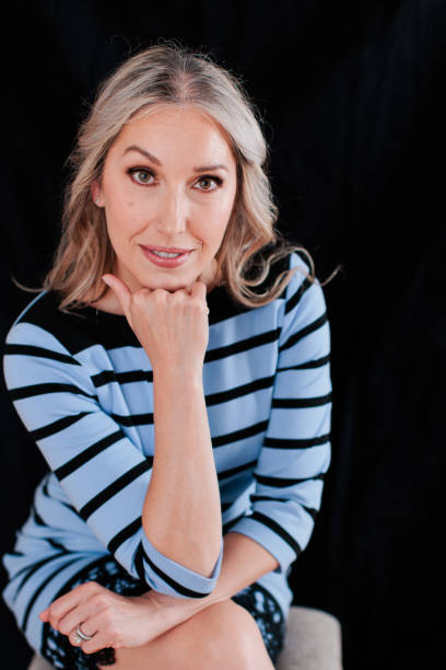 istock Professional woman against black backdrop 1552185732