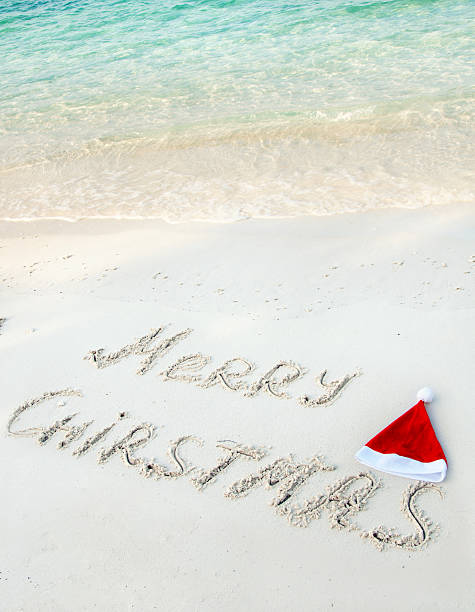 istock Holiday background - Merry Christmas written on tropical beach sand 155218984