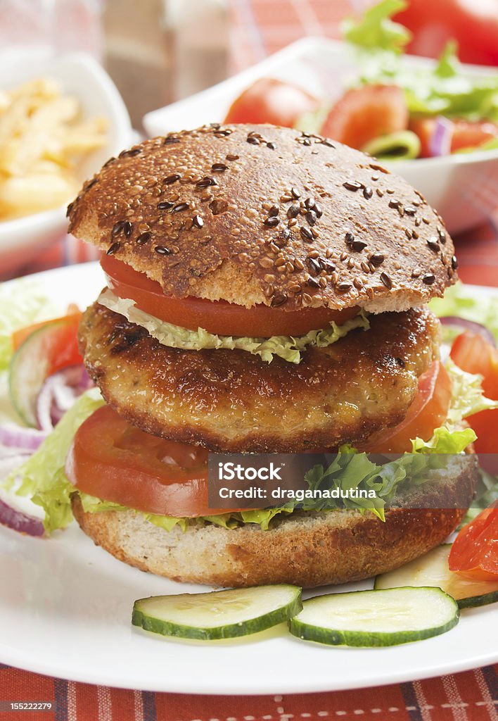 Healthy vegetarian burger Healthy vegetarian soy burger with lettuce and tomato American Culture Stock Photo