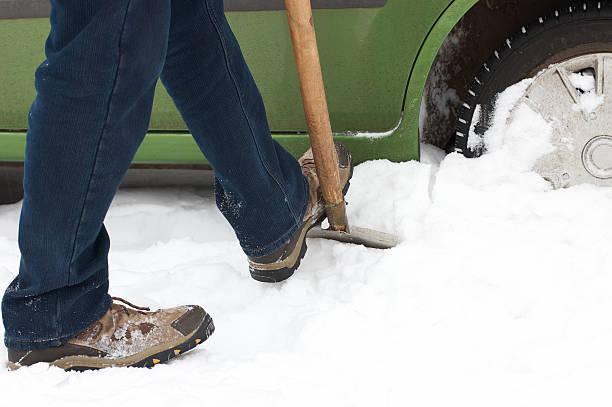 istock Man digging car wheels from the snow 155224301