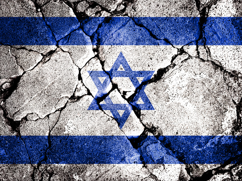 Double exposure of the flag of Israel with cracks in the gravel. A symbol of disintegration or division is depicted. Steps toward collapse. Useful for basemaps or report descriptions