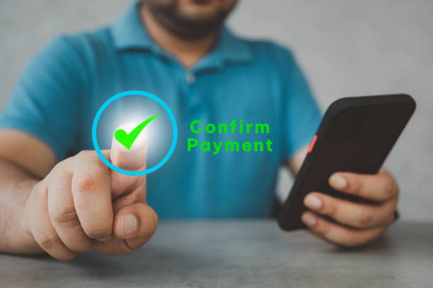 istock Man using mobile phone for online payment and touch on virtual screen for payment confirmed. 1552256294