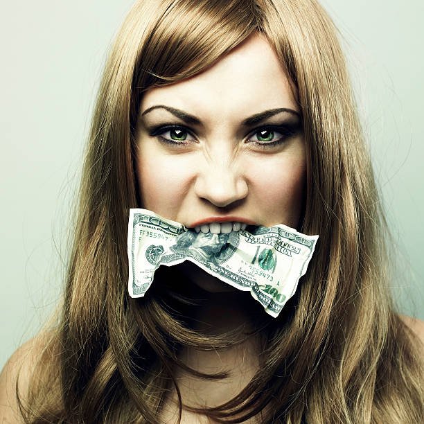 Young woman with 100 US dollars in a mouth stock photo