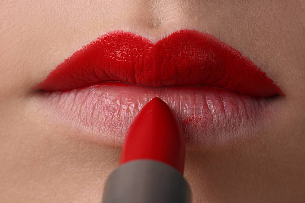 The woman draws lips stock photo