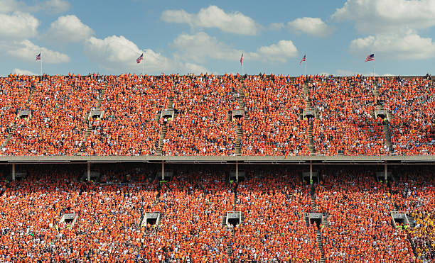 Crowd of thousands Crowd of thousands all dressed in orange bleachers photos stock pictures, royalty-free photos & images