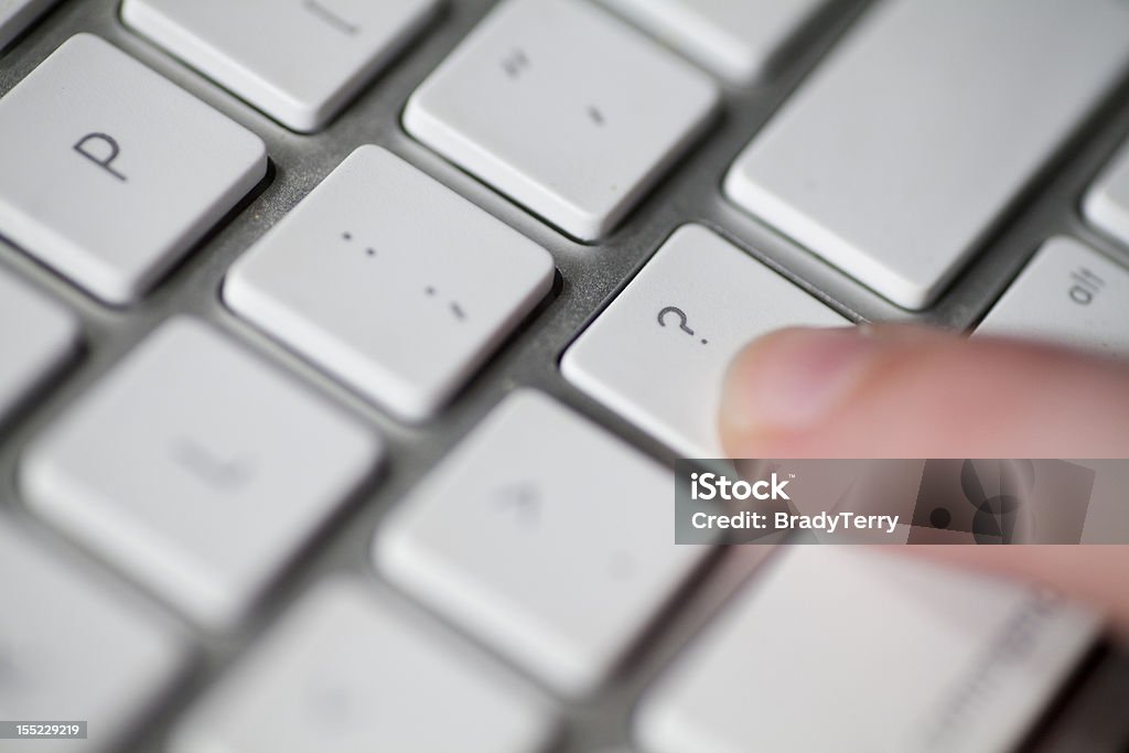 Frequently Asked Questions A person pressing the question mark key on a keyboard. Question Mark Stock Photo