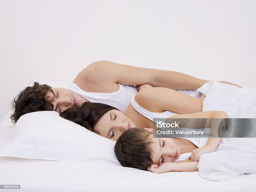Sleeping family with the little son Young beautiful Sleeping family with the little son Adult Stock Photo