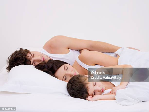 Sleeping Family With The Little Son Stock Photo - Download Image Now - Adult, Beautiful People, Beautiful Woman