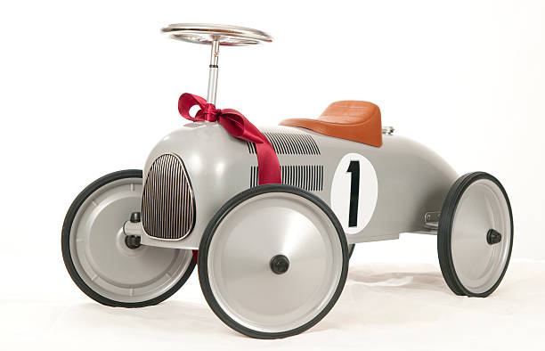 Old-fashioned child's push car on white background