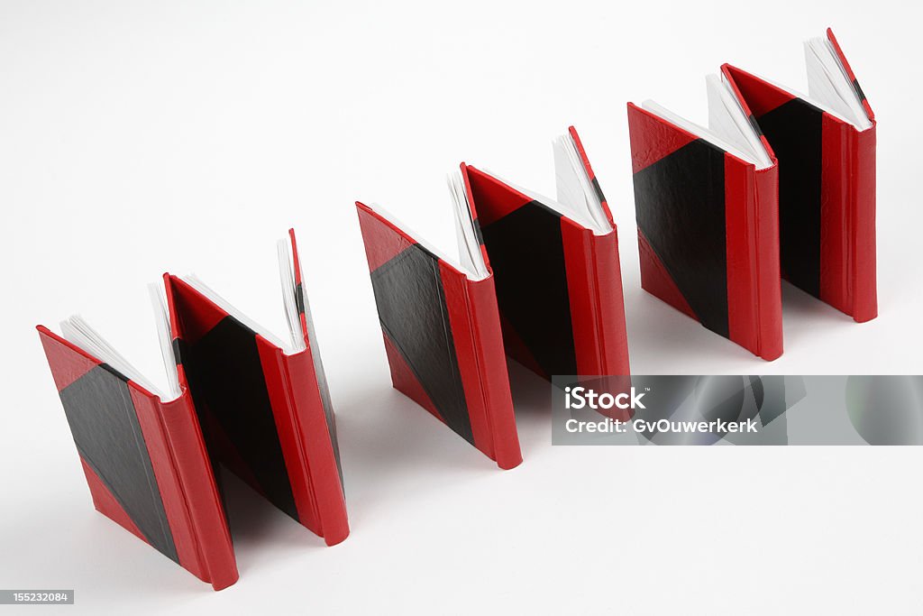 Books forming 'www', tilted shot Six red and black books positioned so that they form the letters 'www' against a white background. Book Stock Photo