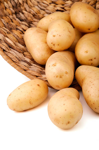 istock Fresh potatoes in a basket, white background 155232825