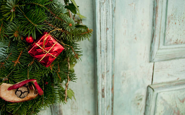 Christmas wreath on rustic doors stock photo